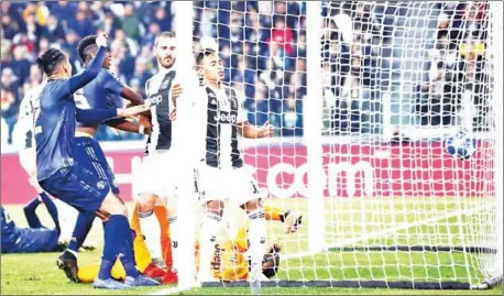  ?? ISABELLA BONOTTO/AFP ?? Manchester United’s Chris Smalling (left) and Paul Pogba (second left) celebrate after Juventus defender Alex Sandro (centre) scores an own goal in their Champions League Group H match at the Allianz stadium in Turin on Wednesday night.