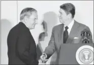  ?? IRA SCHWARZ — THE ASSOCIATED PRESS ?? In this May 8, 1984 file photo, David Rockefelle­r, left, chairman of the Council Americas, shakes hands with President Ronald Reagan at the State Department in Washington.