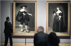  ?? PETER DEJONG / THE ASSOCIATED PRESS ?? People look at the only two full-length portraits Rembrandt ever painted during a Feb. 13 press preview of an exhibition at the Rijksmuseu­m.