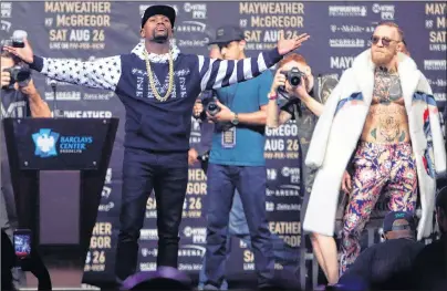  ?? AP PHOTO ?? Floyd Mayweather Jr., front left, poses as Conor McGregor watches during a news conference at Barclays Center on July 13 in New York.