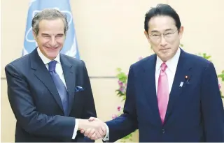  ?? AFP PHOTO ?? UNIFYING TALK
Japan’s Prime Minister Fumio Kishida (right) shakes hands with Director General of the Internatio­nal Atomic Energy Agency (IAEA) Rafael Grossi during their meeting in Tokyo on Friday, May 20, 2022. The leaders of Japan, India, Australia and the United States will meet in Tokyo next week seeking common ground on countering China, despite difference­s over Russia’s invasion of Ukraine.