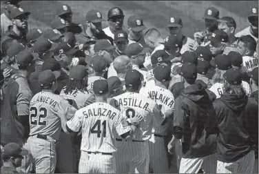  ?? Associated Press ?? Scuffle: Players from the Colorado Rockies and San Diego Padres scuffle after Colorado's Nolan Arenado was hit by a pitch from Padres starting pitcher Luis Perdomo in the third inning of a game Wednesday in Denver.