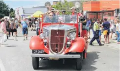  ??  ?? Roll on 2019 . . . Kurow Volunteer Fire Brigade chief fire officer John Sturgeon offers rides yesterday on ‘‘Henry’’, the 1934 Ford V8 fire engine the brigade is restoring.