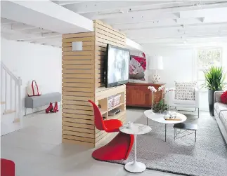  ?? GEOFF HODGDON ?? Architect Bruce Wentworth used drywall and thin strips of birch plywood to turn two awkward beams in this basement into a TV console. Nearly all basements are interrupte­d by a bulky beam that sits in the middle of the room, but it’s important not to...