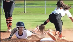  ?? Michelle Petteys, Heritage Snpashots ?? Heritage’s Riley Kokinda slides around a tag attempt by Lafayette’s Haynie Gilstrap during last Tuesday’s 1-0 eight-inning win over the Lady Ramblers.