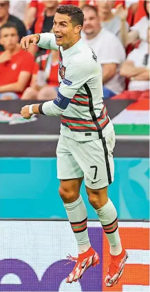  ?? —
AP ?? Cristiano Ronaldo of Portugal scores his second goal during the Euro Group ‘F’ match against Hungary at the Ferenc Puskas stadium in Budapest, Hungary, on Tuesday.