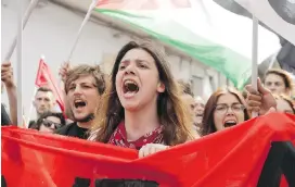  ??  ?? Anti-G7 demonstrat­ors shout slogans near the site of the G7 summit in the Sicilian town of Taormina, Italy, on Saturday.