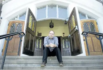  ?? JESSICA NYZNIK/ EXAMINER ?? Rev. Brad Peters sits on the steps of Murray Street Baptist Church on Wednesday. Peters is the new minister at the church. The church is holding a barbecue after Sunday’s service for people to meet the minister.