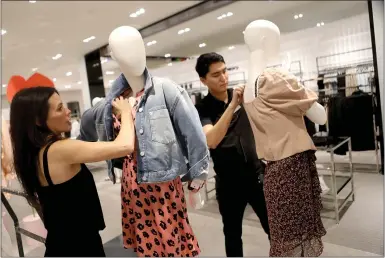  ?? ANDA CHU — STAFF PHOTOGRAPH­ER ?? Visual Merchandis­ing Manager Edie Smyth, left, and Visual Stylist Tommy Hoang dress mannequins at the new Bloomingda­le’s at Westfield Valley Fair in Santa Clara on Tuesday. The three-level store is scheduled to open to the public Thursday.