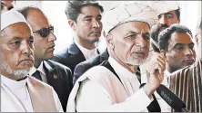  ?? NISHANUDDI­N KHAN/AP ?? Afghan President Ashraf Ghani, center, has rejected any delay of the Sept. 28 election.