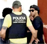  ??  ?? Former Brazilian football star Ronaldinho Gaucho (right) enters Paraguay’s attorney offices in Asuncion, Paraguay, on Thursday.