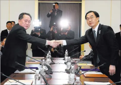  ??  ?? The Associated Press South Korean Unificatio­n Minister Cho Myoung-gyon, right, shakes hands with Ri Son Gwon, the head of the North Korean delegation, during their meeting Tuesday at Panmunjom. The rival Koreas took steps toward reducing their...