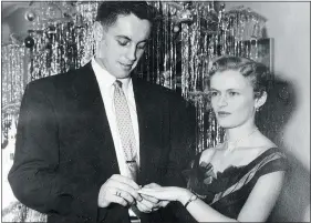  ?? RIC ERNST/PNG FILES
— THE CANADIAN PRESS FILES ?? Jean Beliveau slips an engagement ring on Elise Couture in 1952. The former Montreal Canadien died last week.