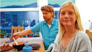  ??  ?? Anna Thulin-Myge, 10, sits down for dinner next to her stepfather, Ola Vassbo, in Haugesund, Norway. Anna was born a boy but never felt like one. Soon, she is likely to receive a letter confirming she legally is a girl.