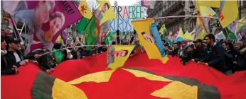  ?? (Christian Hartmann) ?? MEMBERS OF the Kurdish community hold banners and flags in Paris yesterday, during a protest about three Kurdish women who were shot dead on January 10, 2013.