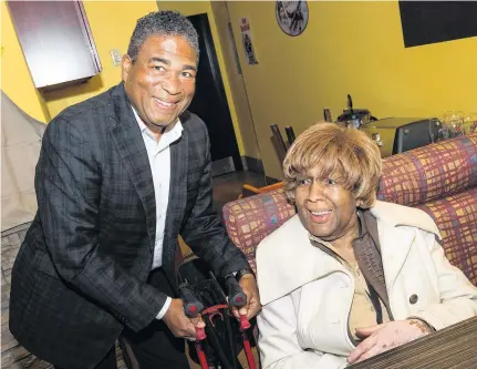  ?? FILE ?? Tony Ince helps his mother, Thelma Coward-ince, to a seat at his election campaign headquarte­rs three years ago.