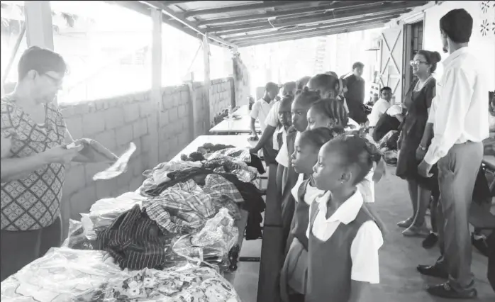  ??  ?? Annette Jaundoo (left) with children at a FACT after-school programme