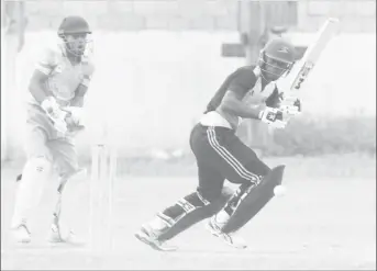  ?? (Orlando Charles Photo) ?? Sherfane Rutherford works one into the leg side during his innings yesterday