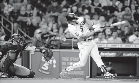  ?? Karen Warren/Staff photograph­er ?? A catcher interferen­ce call against the Rangers’ Sam Huff affects Jeremy Peña‘s swing and allows him to reach in the first inning.