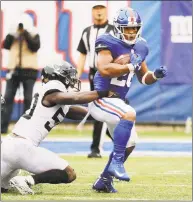  ?? Seth Wenig / Associated Press ?? The New York Giants’ Saquon Barkley is tackled by the Jacksonvil­le Jaguars’ Telvin Smith during the second half on Sept. 9.