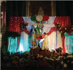  ?? SUBMITTED PHOTOS ?? Above, the display of Juan Diego and Our Lady of Guadalupe is adorned with flowers in front of St. Patrick’s Church. at left, the faithful gather in St. Patrick’s Church for a Mass celebratin­g the feast day of Our Lady of Guadalupe.