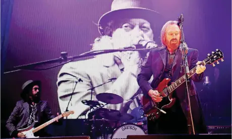  ?? [PHOTO BY DOUG HOKE, THE OKLAHOMAN ARCHIVES] ?? Tom Petty and the Heartbreak­ers perform April 20 during the 40th anniversar­y tour stop at the Chesapeake Energy Arena in downtown Oklahoma City.