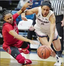  ?? SEAN D. ELLIOT/THE DAY ?? UConn’s Mikayla Coombs, right, drives by Cincinnati’s Antoinette Miller in the first half of Wednesday’s game at Gampel Pavilion.