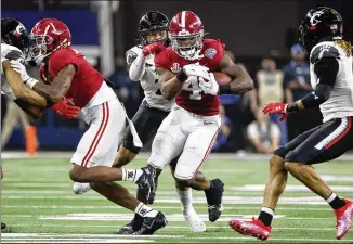 ?? MICHAEL AINSWORTH/AP ?? Alabama running back Brian Robinson Jr. (center) runs for a first down in Friday’s Cotton Bowl in Arlington, Texas. Robinson was offensive MVP, running for 204 yards on 26 carries.