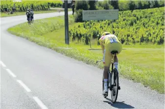  ?? THE ASSOCIATED PRESS ?? Slovenia’s Tadej Pogacar, wearing the overall leader’s yellow jersey, competes in the 20th stage of the Tour de France, an individual time-trial, on Saturday.