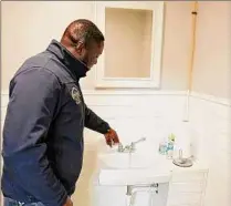  ?? Photos by Will Waldron / Times Union ?? Kevin Maxwell, owner of Maxwell Home Inspection Services, recreates one of the responsibi­lities he carries out during a home inspection: Checking the water flow in a home’s sinks.