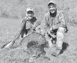  ?? STEVE WATERS For the Miami Herald ?? Robert ‘RC’ Callaway, right, and Steve Waters with a wild turkey gobbler that Callaway called in on the last day of the spring turkey season last year.