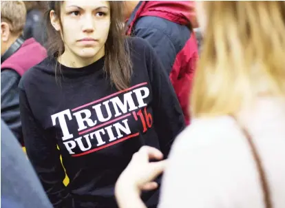  ?? | DAVID GOLDMAN/AP ?? At a Donald Trump campaign event in New Hampshire in February, a woman wears a shirt reading ‘Trump Putin ‘16’.