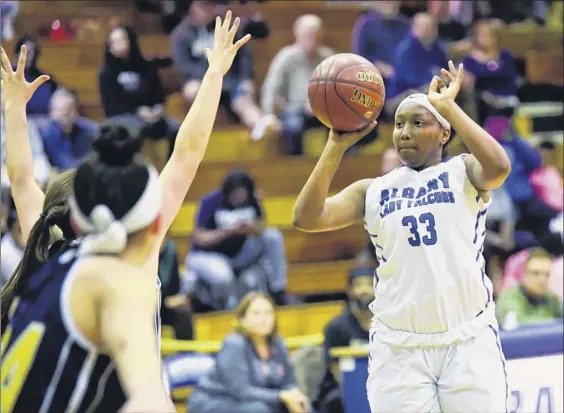  ?? Photos by Hans Pennink / Special to the Times Union ?? Albany’s Hasinja Gaddy puts up a shot over Averill Park during the first half of their game Friday. Gaddy finished with 11 points and seven rebounds.