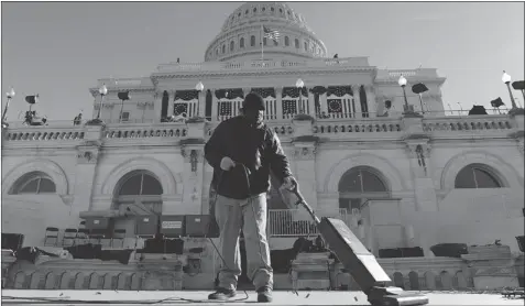  ?? JEWEL SAMAD/ AFP/GETTY IMAGES ?? A worker on Friday helps prepare the U.S. Capitol in Washington for the second inaugurati­on of President Barack Obama on Monday.