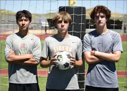  ?? BRENT W. NEW — BOCOPREPS.COM ?? From left, Erie’s Mason Guven, Tyler Hoffman and Jacoby Latessa pose for a photo at practice Tuesday at the school.