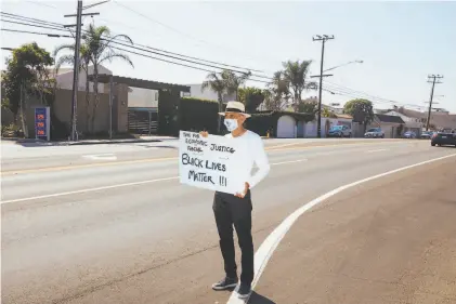  ?? David Walter Banks / Special to The Chronicle ?? Jack Kornfield, Buddhist practition­er and cofounder of Spirit Rock in Marin County, protests for Black Lives Matter along Pacific Coast Highway in Malibu. He protests daily in San Rafael and continued the practice in a visit to Los Angeles.