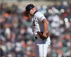  ?? PHOTOS BY PAUL SANCYA — THE ASSOCIATED PRESS ?? Detroit Tigers pitcher Alex Lange (55) reacts after walking in a run against the Minnesota Twins in the 12th inning during the first game of a doublehead­er, Saturday in Detroit.