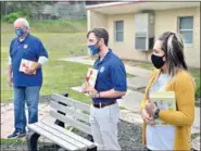  ??  ?? Members of the Kiwanis Club visited Northwest Elementary today, where they distribute­d copies of “Fox in Socks” to students. (Marvin Richards/ News-Times)