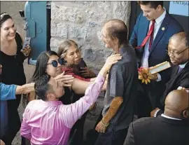  ?? Paul Ratje AFP/Getty Images ?? ANTONIO BASCO is comforted by some of those who came, often from far away, to honor Margie Reckard, his longtime partner who died in the El Paso massacre.