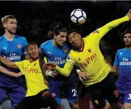  ??  ?? Troy Deeney puts his head in where it hurts in a challenge with Hector Bellerin during Watford’s victory over Arsenal