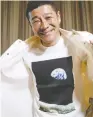  ?? KIM KYUNG-HOON / REUTERS ?? Japanese billionair­e Yusaku Maezawa flashes a T-shirt bearing the iconic “Earthrise” image during an interview Wednesday.