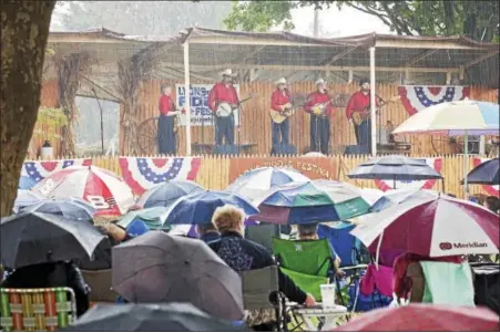  ?? ROXANNE RICHARDSON - FIDDLE FESTIVAL ?? Crow Hill took the stage right after the gospel service even though the rain poured down on the Lyons Fiddle Festival on Sept. 18.