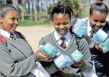  ?? PICTURE: CINDY WAXA ?? EXTRA SUPPORT: The organisati­on Caring for Girls handed out sanitary towels to girls at Silikamva High School in Hout Bay. From left to right are Christelin­e Knowles, Nonceba Toto and Indiphile Nqevu.