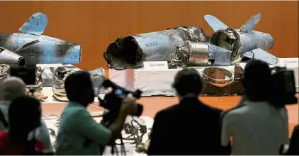  ?? — Reuters ?? Destructiv­e force: People looking at the remains of the missiles which Saudi government says were used to attack an Aramco oil facility are displayed during a news conference in Riyadh.