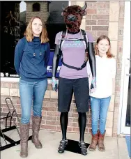  ?? Lynn Atkins/Special to The Weekly Vista ?? Gretchen and Elise McCann pose with the new Bison Bikes mascot during a demo day on Sunday. The name Bison Bikes is derived from shop owner Kendall McCann’s middle name, Byson, which is also his mother’s maiden name.