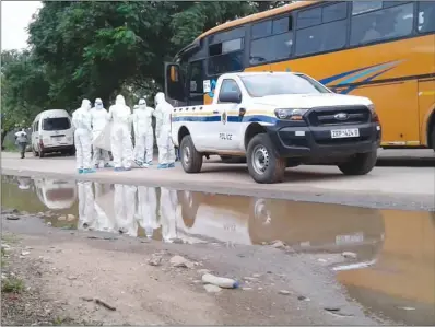  ??  ?? Beitbridge police prepare to remove the body of a passenger (name withheld) from a Devine Logistics bus in which he died while en route to Zimbabwe yesterday. The passenger was said to have been headed for Checheche in Chipinge.