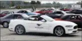  ?? CARLOS OSORIO — THE ASSOCIATED PRESS ?? A 2019 GT Mustang, the 10 millionth Mustang built by Ford drives by a group of previous model Mustangs on a parking lot at the Flat Rock Assembly plant, Wednesday in Flat Rock, Mich.