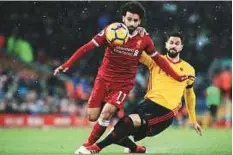  ?? AFP ?? ■ Liverpool’s Mohammad Salah (left) vies with Watford’s Etienne Capoue during last weekend’s clash at Anfield.