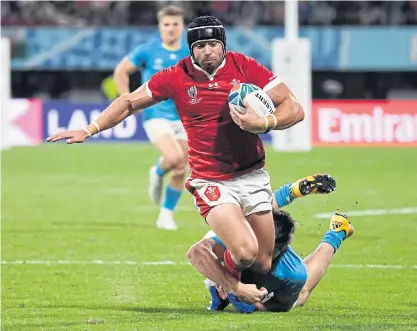  ??  ?? Wales’ Leigh Halfpenny is tackled during a match at the 2019 Rugby World Cup.