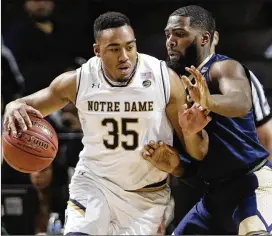  ?? FRANK FRANKLIN II / AP ?? Notre Dame’s Bonzie Colson, being defended by Pitt’s Jared Wilson-Frame, had 19 points as the Irish advance to play Virginia Tech in the ACC Tournament.